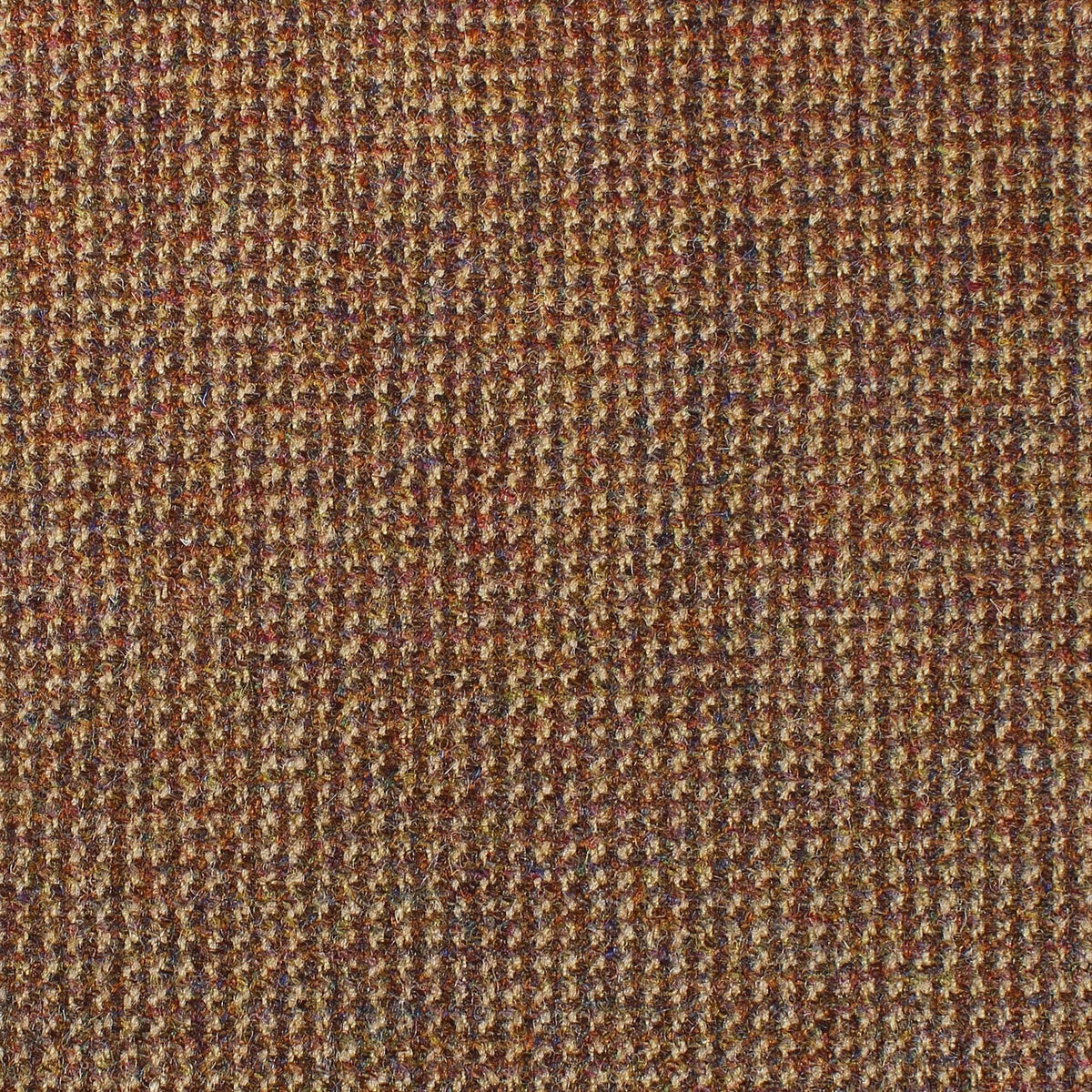 Close-up of Estate Tweed 046 by Lovat Mill, featuring a brown, orange, and blue Scottish tweed with a textured herringbone weave.