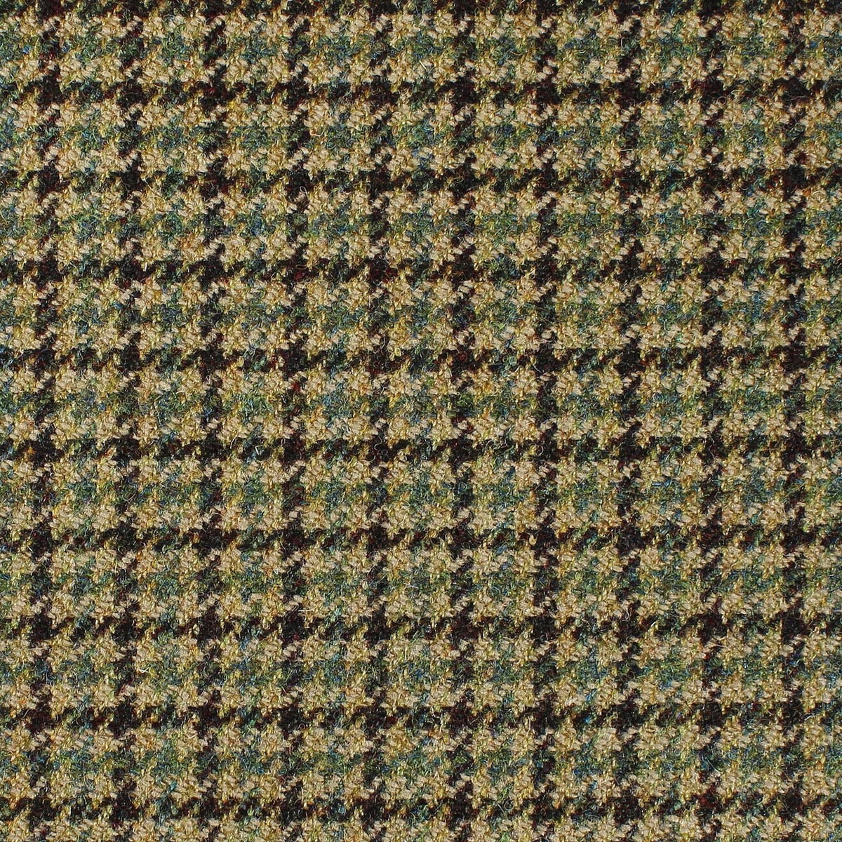 Close-up of Estate Tweed 055, featuring a brown, tan, and blue houndstooth patterned tweed fabric.