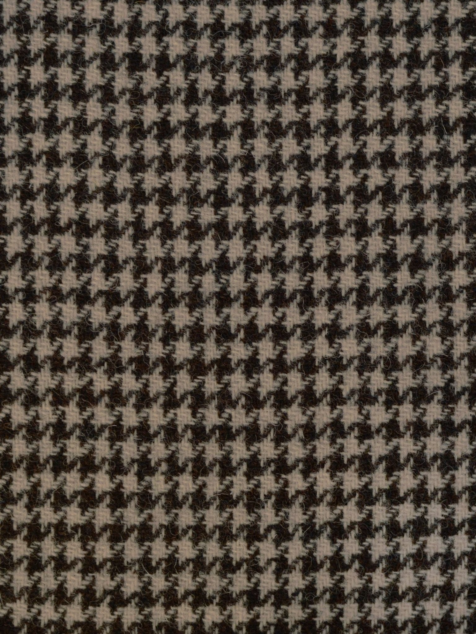 Close-up of Campbell's of Beauly House Tweed 93898: black and white houndstooth fabric with a geometric, jagged pattern—a classic tribute to Scottish weaving tradition.