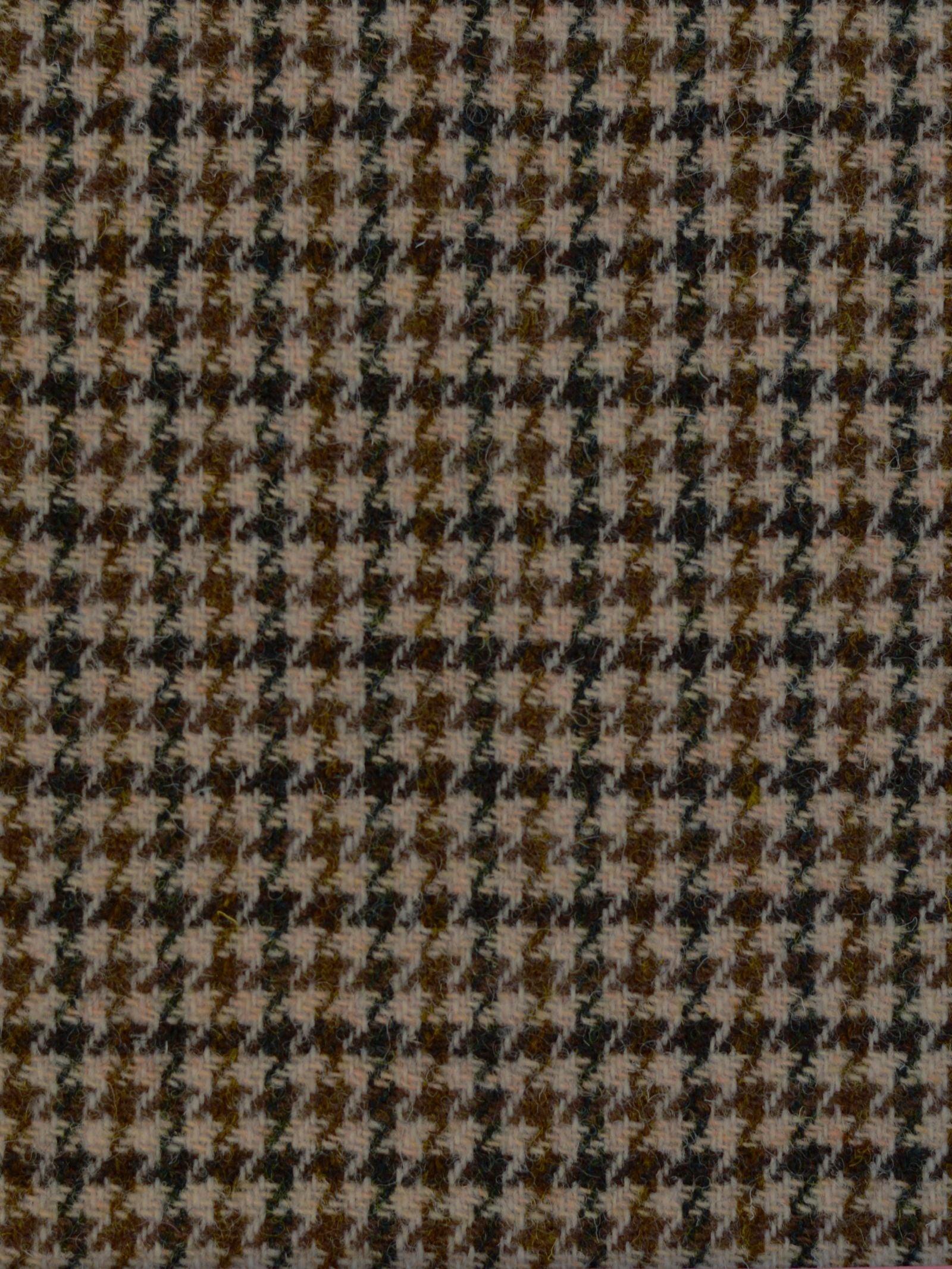 A close-up of House Tweed 93909 by Campbell's of Beauly shows its classic brown and gray houndstooth pattern with a distinctive jagged, checkered design.