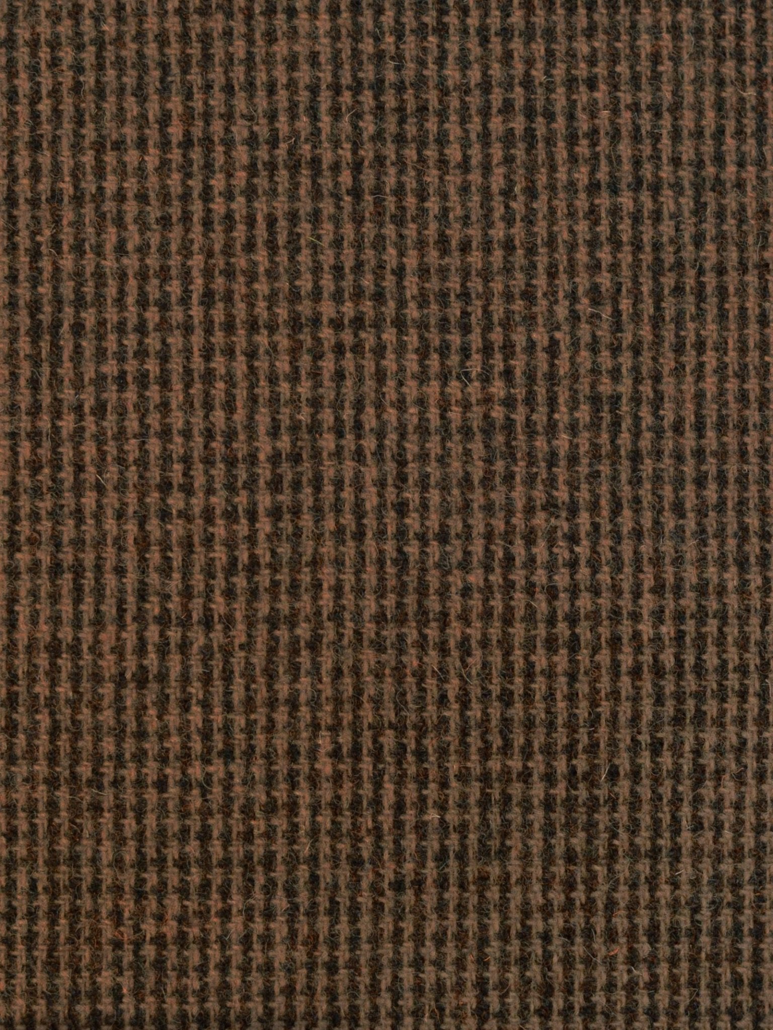 Close-up of House Tweed 93905 by Campbell's of Beauly, featuring a textured brown and black houndstooth-patterned woven fabric that highlights the tightly-knit quality typical of Scottish craftsmanship.