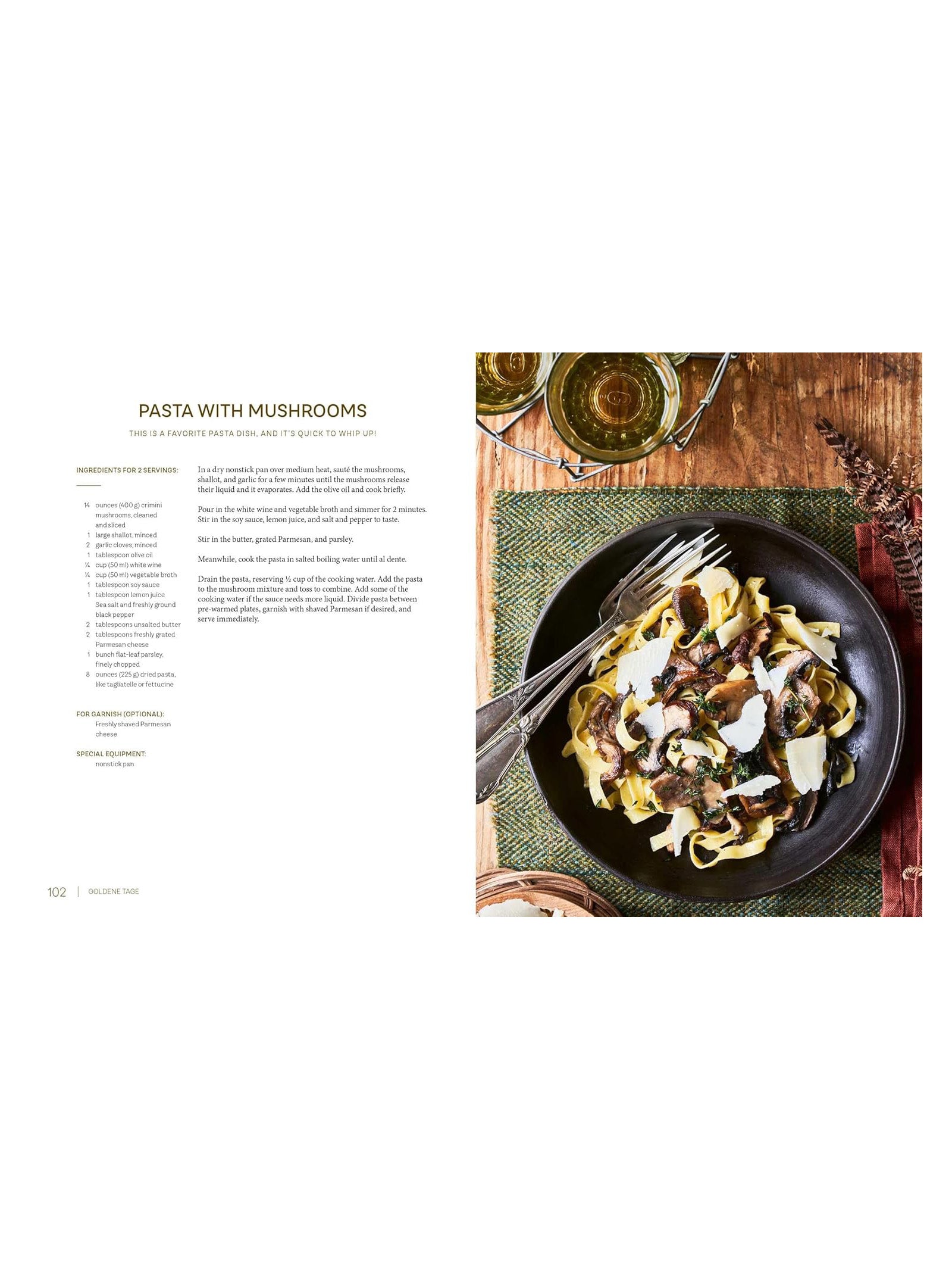 An overhead view of the Highland Harvest Book by Campbell's of Beauly, open to a pasta with mushrooms recipe, beside a plate of mushroom pasta topped with cheese, a fork, and a green napkin on a rustic wooden table.