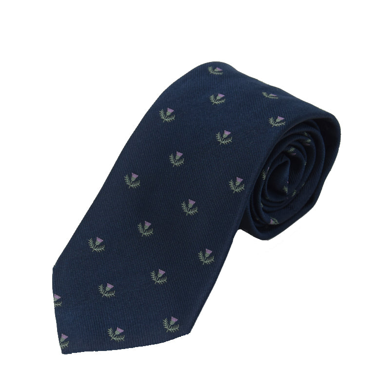 The Thistle Silk Tie by Campbells of Beauly features embroidered purple thistles and green leaves on navy silk—ideal for formal events or celebrating Scottish heritage. Shown neatly rolled on a white background.