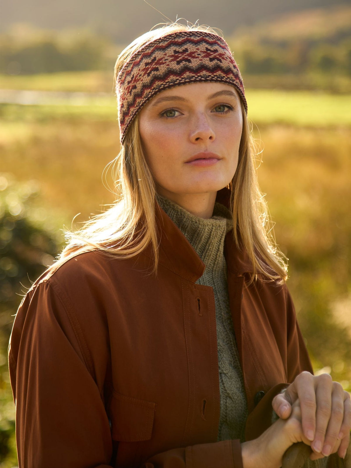 A person wearing a patterned, 100% wool Campbell’s of Beauly Fairisle Headband.