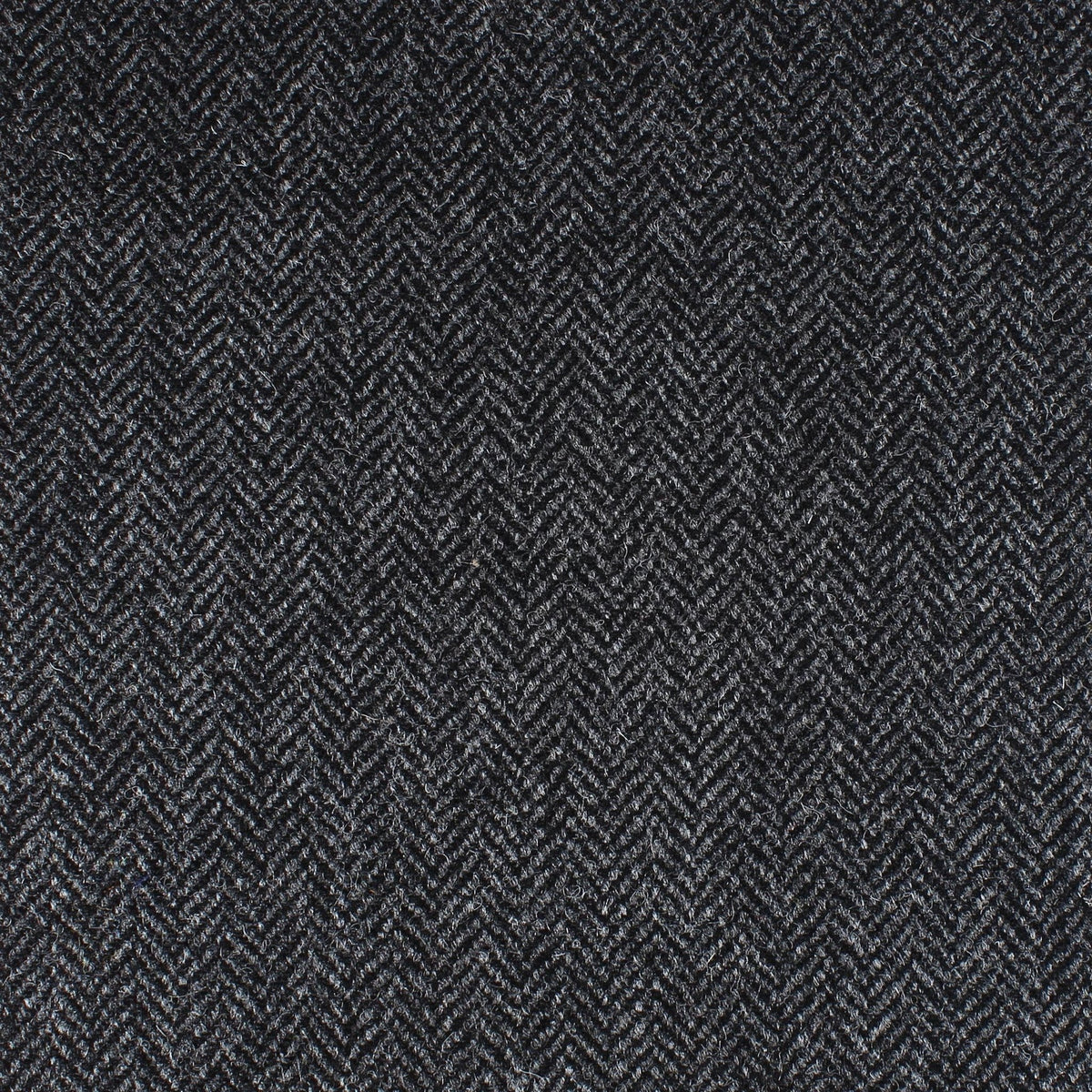 Field Tweed 118 by Lovat Mill is a dark gray fabric featuring a fine herringbone weave that evokes classic Scottish tweed—perfect for timeless country clothing.