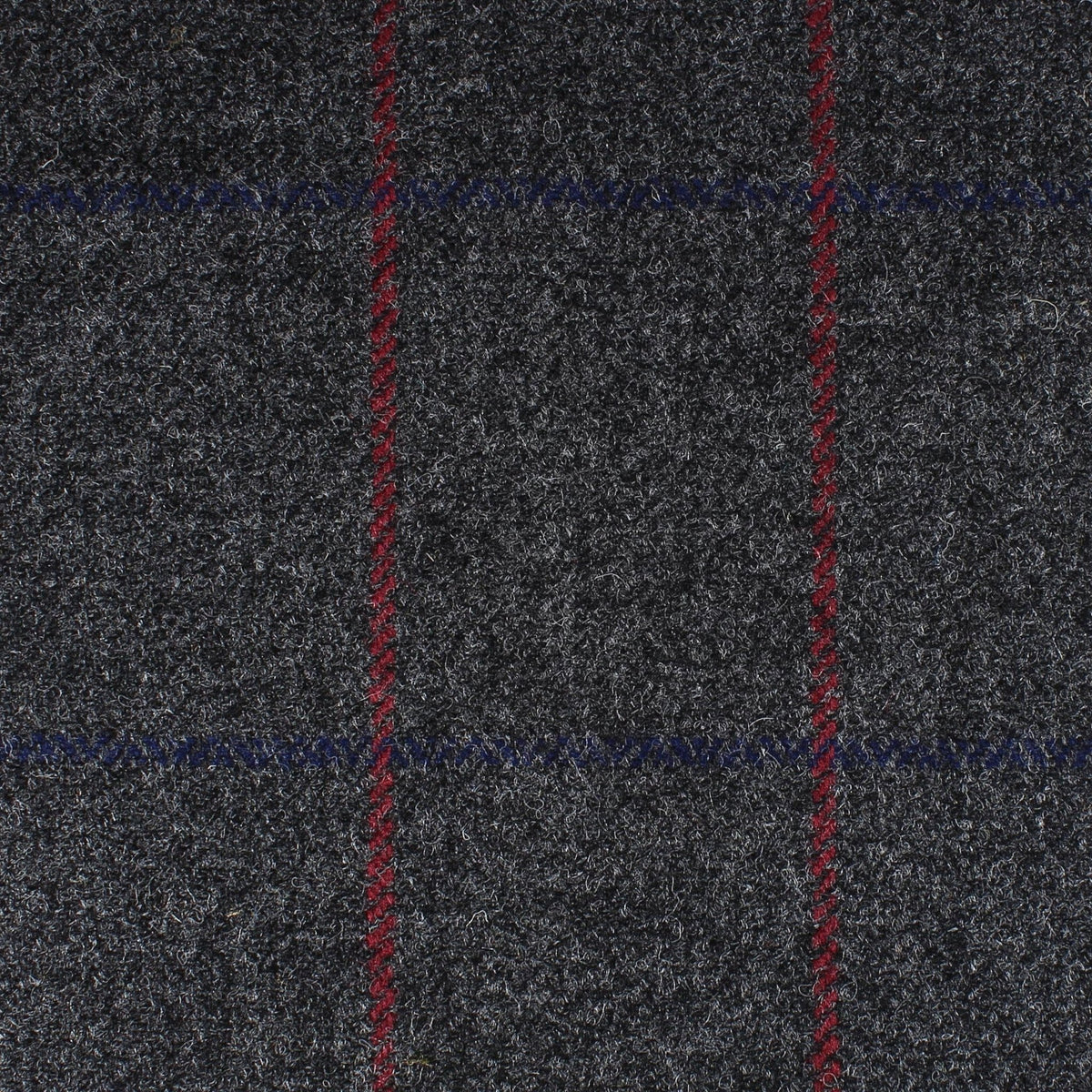 Field Tweed 119 in dark gray 100% wool Scottish tweed featuring a subtle blue and bold red windowpane check pattern.