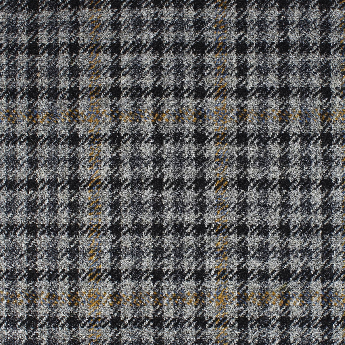 Field Tweed 151 by Lovat Mill is a 100% wool Scottish tweed with grey, black, and blue glen plaid plus gold and brown overchecks—ideal for timeless country clothing styles.