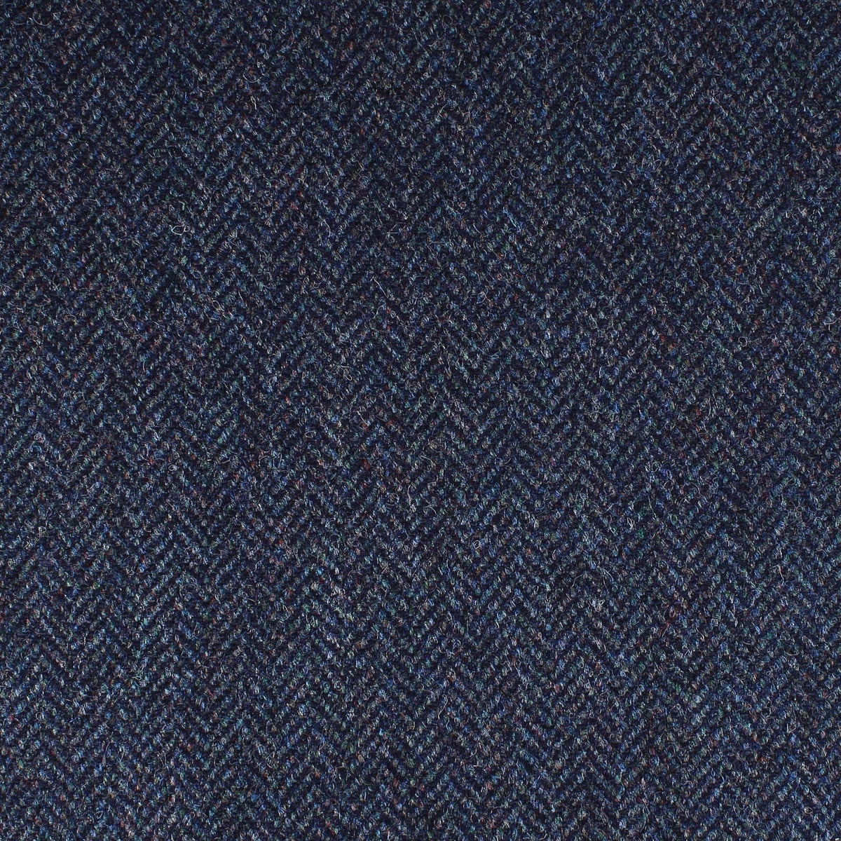 Field Tweed 155 by Lovat Mill is a dark navy blue Scottish tweed with a subtle multicolored herringbone weave, ideal for classic country clothing.