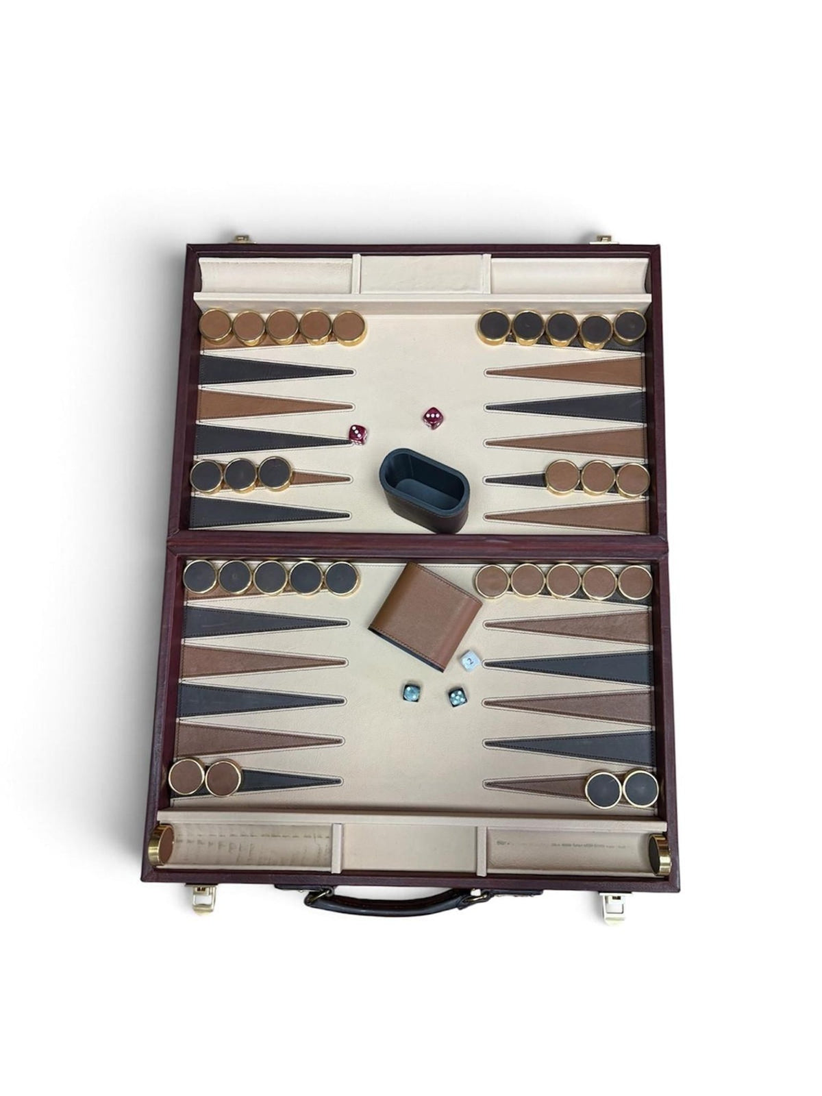 Experience the classic charm of traditional gameplay with the Rey Pavón Leather Backgammon Set. This luxurious set showcases a beautifully open leather surface with rich brown and beige triangles, complete with neatly arranged game pieces on both sides. It includes two dice cups, dice, and a doubling cube—each thoughtfully positioned on the elegant board. Designed for sophisticated portability, the case features an integrated handle and secure latches, blending convenience with style.