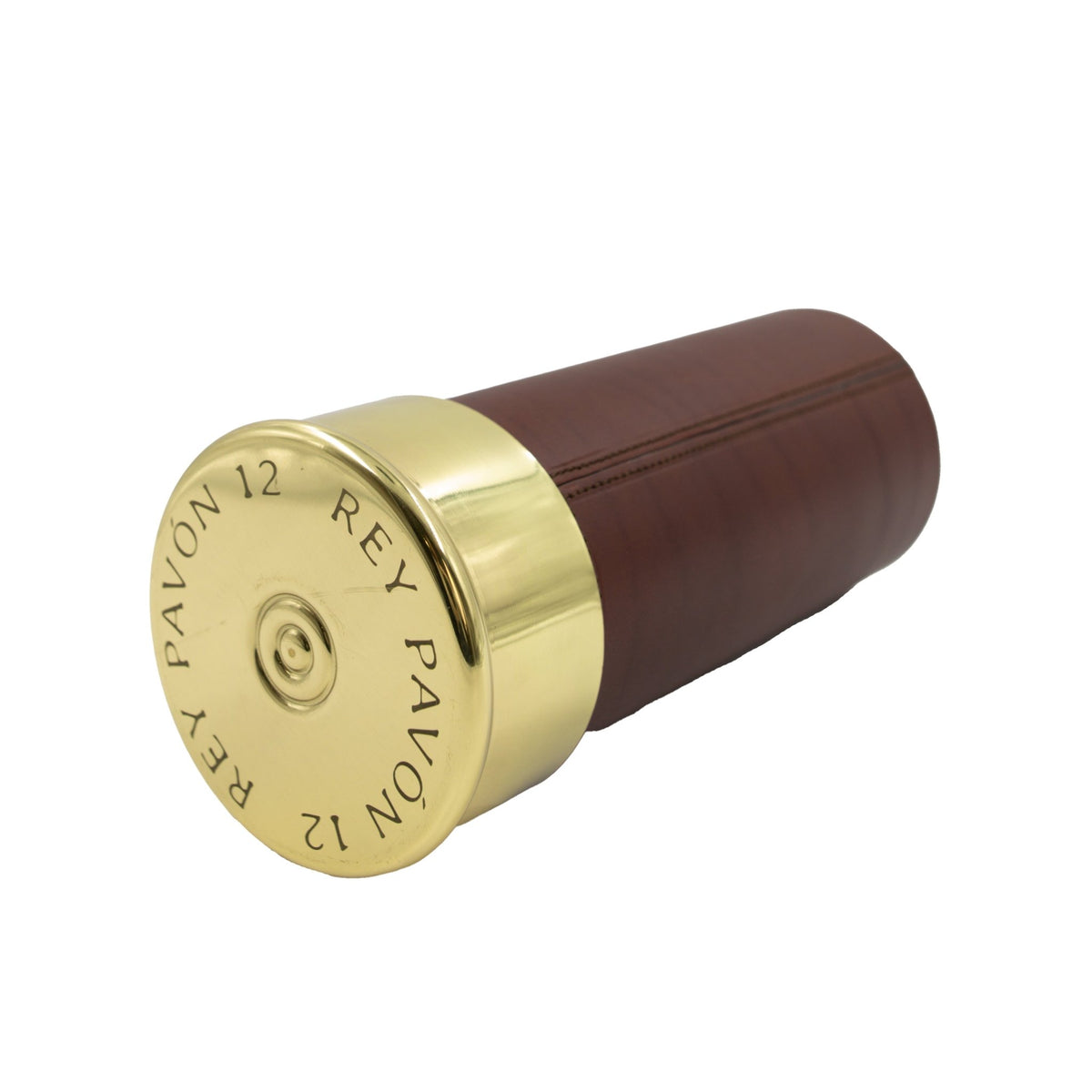 A brown cylindrical leather Shotgun Cartridge Cigar Humidor by Rey Pavón, featuring a shiny gold-colored cap engraved with “REY PAVÓN 12” in a circular pattern around the edge. The interior is cedar-lined to help preserve your cigars’ freshness and aroma.