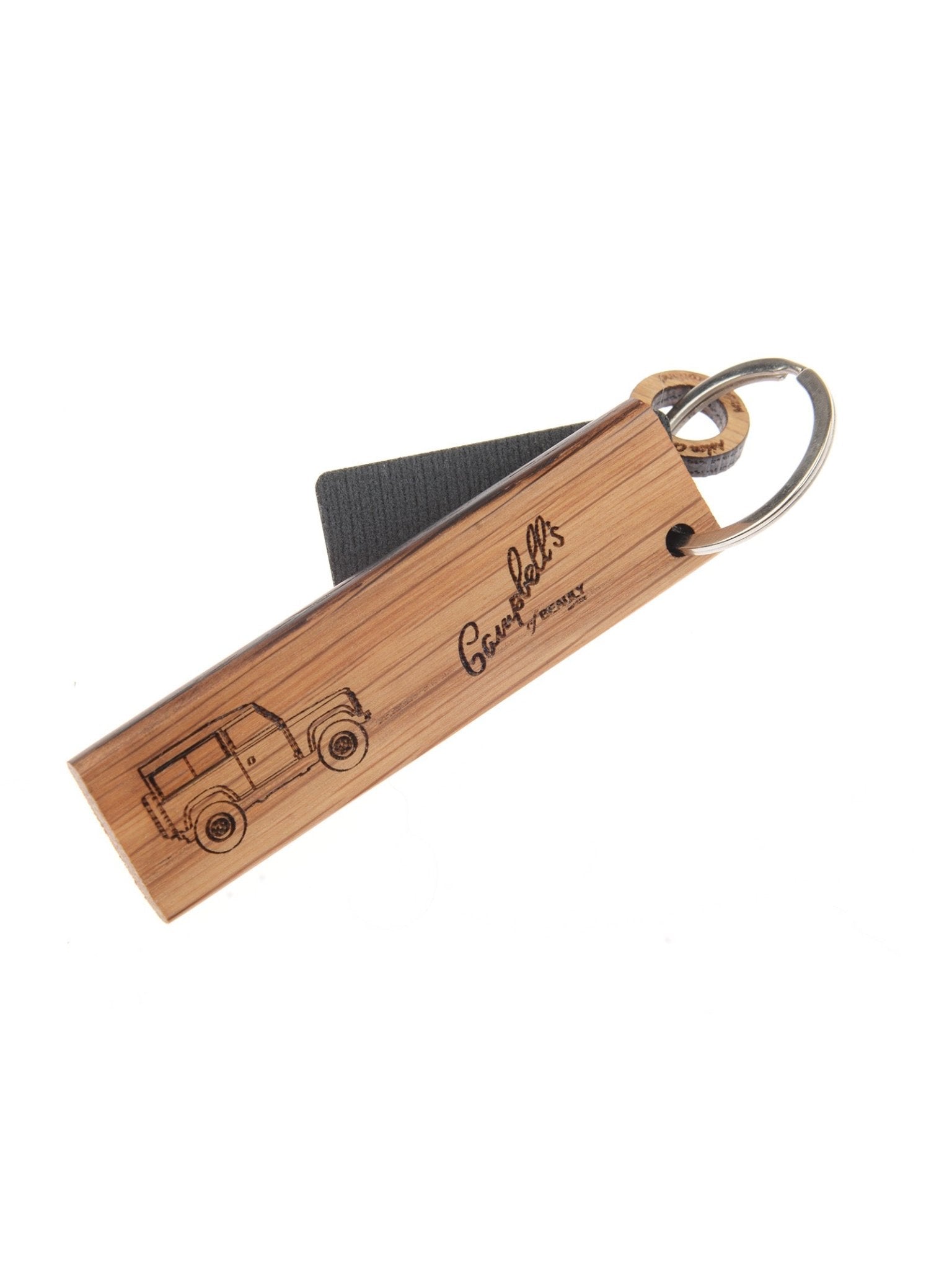 The Campbell's of Beauly Whisky Barrel Keyring (Land Rover Defender) is handcrafted from whisky barrel oak, engraved with a Defender sketch and “George Pollitt’s Present,” and finished with a metal ring and small black leather strap.