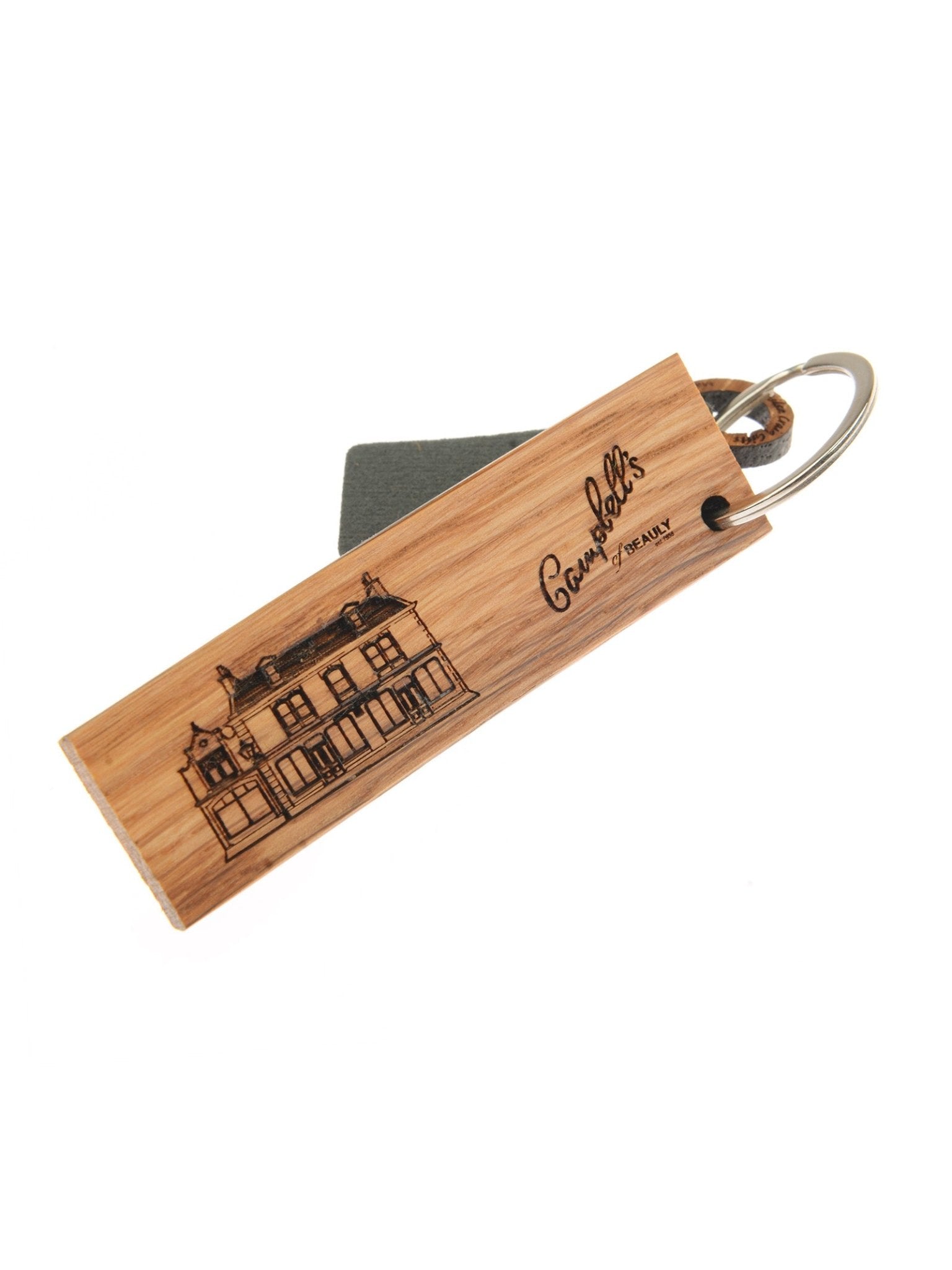 The Whisky Barrel Keyring (Beauly) by Campbell's of Beauly is crafted from reclaimed whisky barrel oak, engraved with a building and "Gannets Grantham," and comes attached to a metal ring with a grey tag.