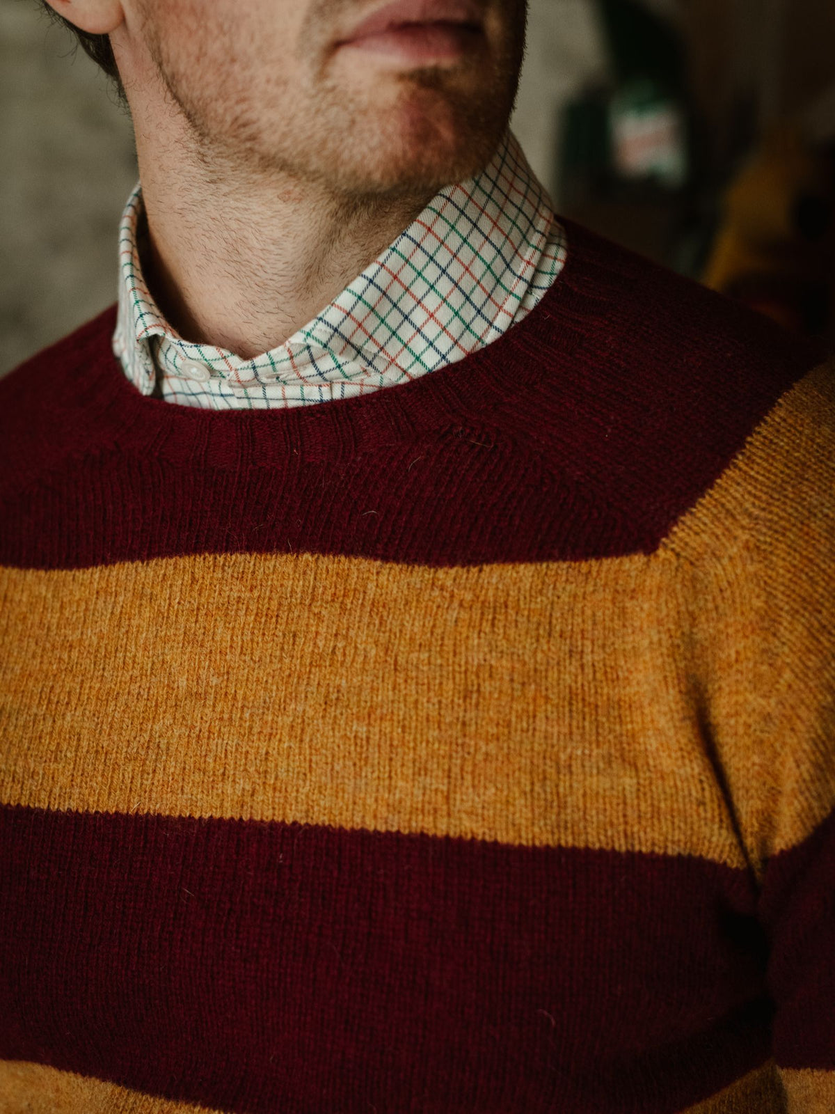 A person wearing Campbell’s of Beauly Windowpane Shirt—crafted from white brushed cotton—with only the lower half of their face visible, their eyes outside the frame.