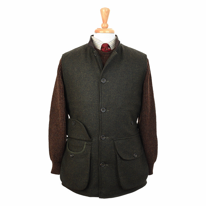 The Field Nehru Gilet by Campbells of Beauly, a dark green tweed gilet with quilted lining and stand collar, is displayed on a mannequin over a brown knit sweater, white checked shirt, and red patterned tie.