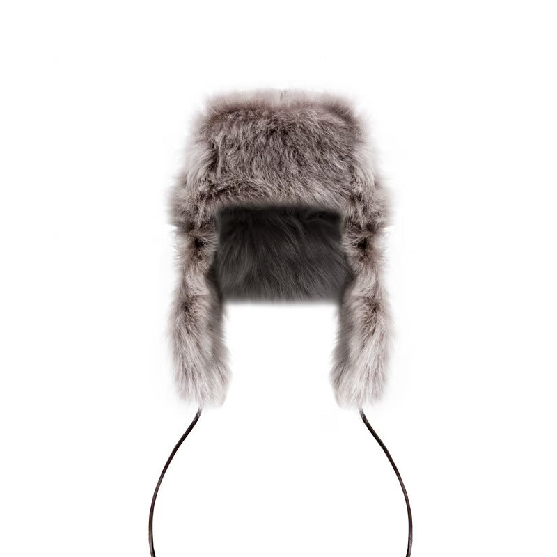 The Campbells of Beauly Toscana Sheepskin Trapper Hat features thick, fluffy gray fur, cozy ear flaps, and long strings. This luxurious cold-weather accessory is displayed on a white background.