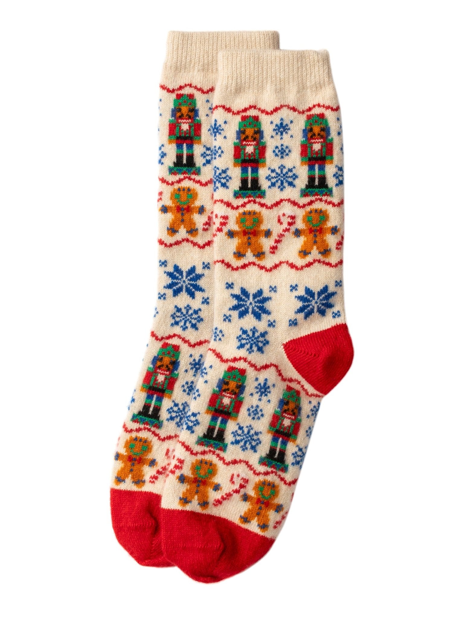 Campbell's of Beauly Nutcracker Cashmere Socks in Winter White feature festive red heels and toes, decorated with nutcrackers, gingerbread men, and blue snowflakes.