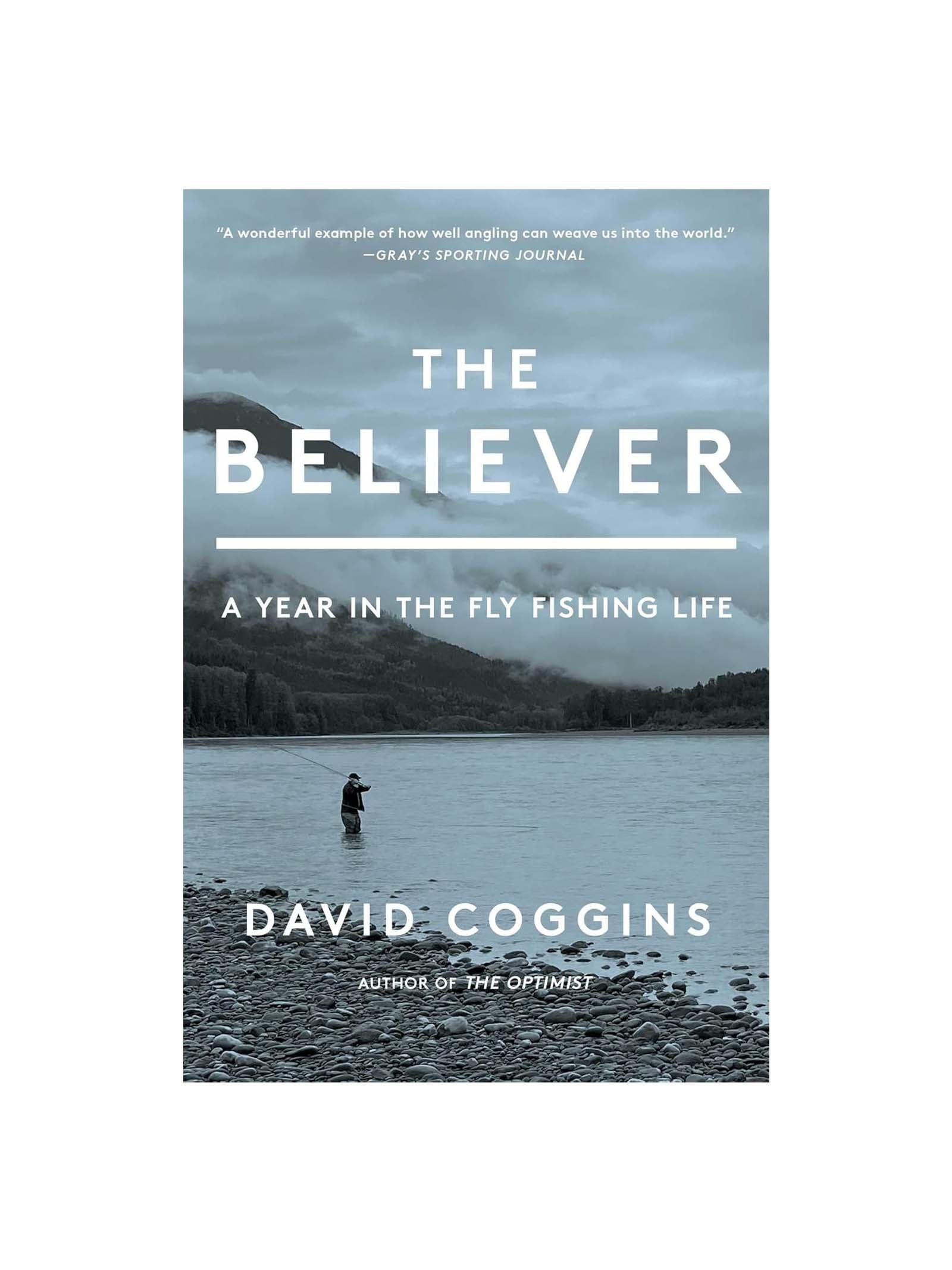 Book cover for The Believer: A Year in the Fly Fishing Life by David Coggins, showing a fly fisher on a tranquil lake with mountains and trees under a cloudy sky.