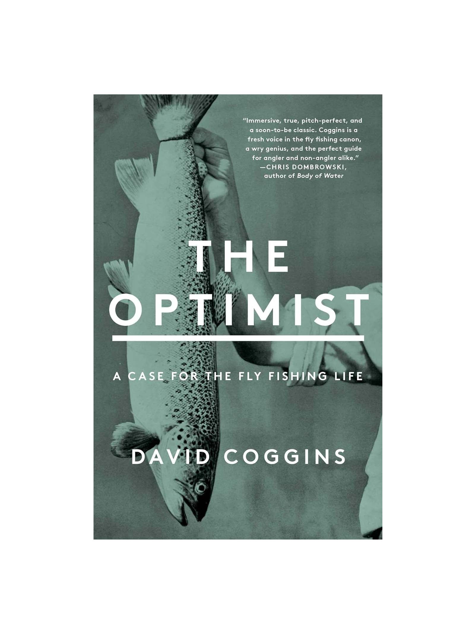 A person holds a large fish horizontally with both hands. Overlaid text reads: The Optimist: A Case for the Fly Fishing Life by David Coggins. A review blurb is shown in the top right corner.
